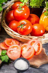 Fresh tomato and herbs in a basket