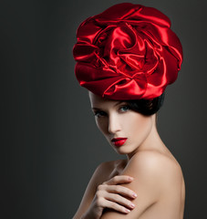 fashionable woman with a satin rose in her hair