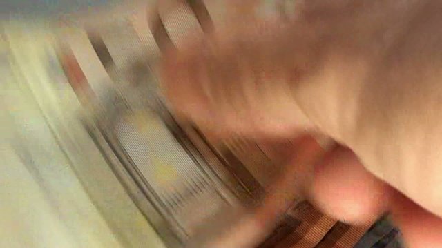 hand of a banker who has a lot of money in euro banknotes