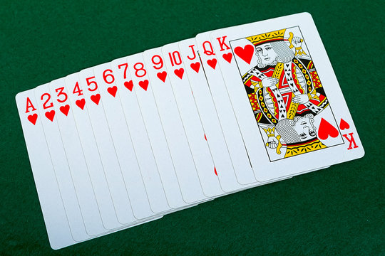 Playing cards red deck on the green background