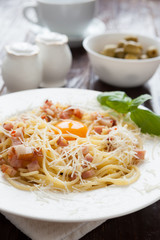 Spaghetti carbonara with grated parmesan cheese