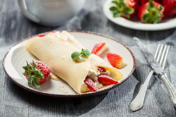 Closeup of strawberry pancakes sprinkled with icing sugar