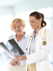 Female doctor talking with senior patient
