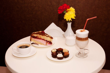 Cake, candies and coffee in a cafe