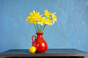 spring narcissus in red vase and yellow ball © Alis Photo