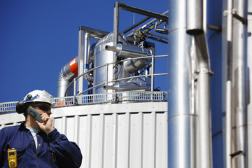 oil worker and main fuel station inside oil refinery