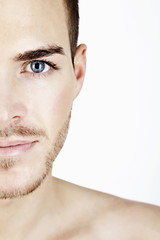 Portrait of a sportive young man isolated on white half face