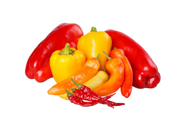 Group of ripe, hot and mild peppers isolated against white