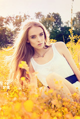 young girl lying on a flower glade