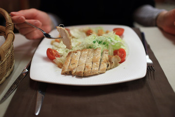 Person eating chicken salad