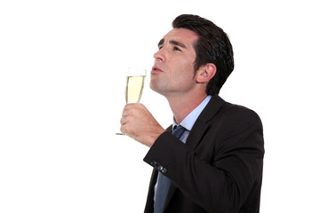 Businessman, drinking champagne, alone