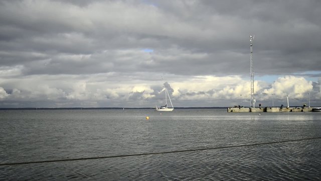Boat is mooving in marina of Curonian spite, Neringa