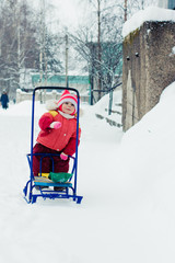 Beautiful happy kid in the red warm clothing.