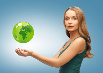 woman holding green globe on her hands
