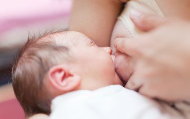 Nursing newborn baby
