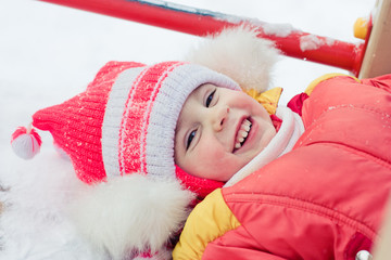 Beautiful happy kid in the red jacket