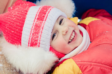 Beautiful happy kid in the red jacket