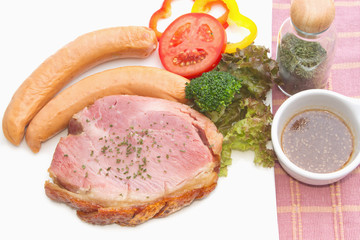 smoke ham steak with smoked sausage on the white plate