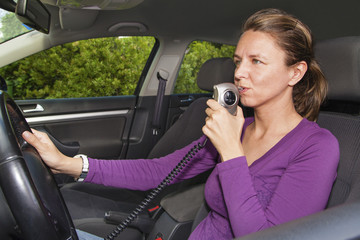 Woman blowing into breathalyzer