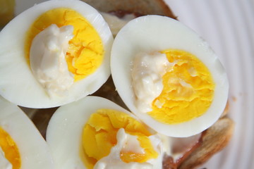 Halved and hard boiled egg yolks with a dab of mayonnaise