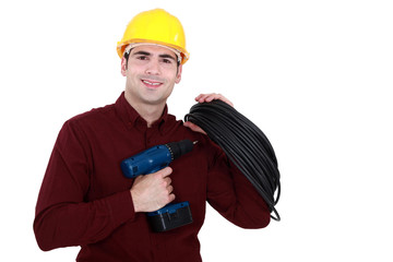 electrician holding drill and cable