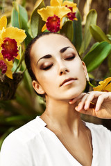 young beautiful woman with yellow wreath of orchids