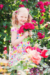 happy girl with roses in garden