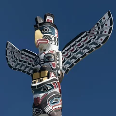 Garden poster Indians A totem wood pole in the blue cloudy background