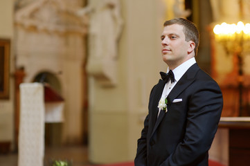 Groom waiting for the bride in church