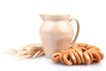 jar of milk, tasty bagels and spikelets, isolated on white