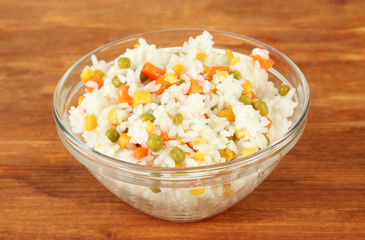 Risotto in bowl on wooden background