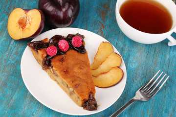 Tasty pie on plate on wooden table
