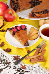 Tasty pie on plate on wooden table