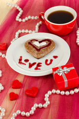 Chocolate cookie in form of heart with cup of coffee