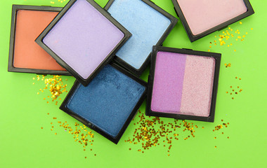 Beautiful bright eye shadows on green background