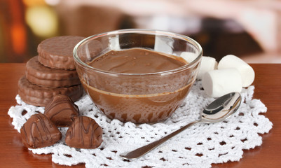 Bowl of chocolate and sweets on table in cafe