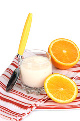 Delicious yogurt in glass with orange isolated on white