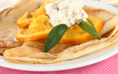 Pancakes with orange on napkin close-up