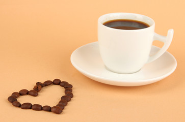 Cup of strong coffee on beige background