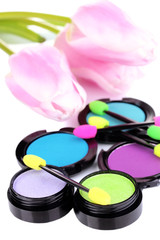 Bright eye shadows and sponge brushes for foundation close up