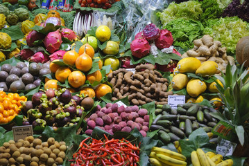 Various fruits and vegetables at market - mangosteen, passion fruit, tamarind, pitaya, dragon fruit - La Boqueria, Barcelona