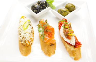 spanish sandwiches with seafood , cheese and vegetables