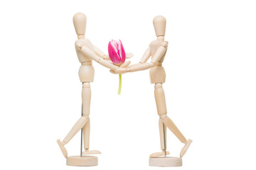 wooden little man giving flower on the isolated white