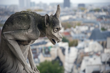 Stone gargoyle overlooking Paris from the Notre Dame - Powered by Adobe