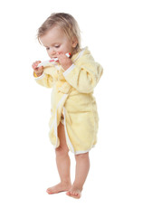 Little girl brushing her teeth isolated on white background