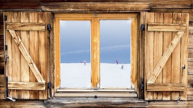 mountain hut window skiing scene reflection