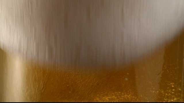 Pouring beer into a glass.