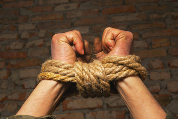 Hands tied up with rope