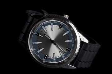 Men's metalic wristwatch, isolated on black background