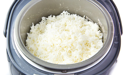 Stream rice in electric rice cooker isolated on a white backgrou